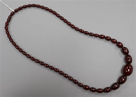 A single strand graduated simulated amber necklace, gross 53 grams, 74cm.